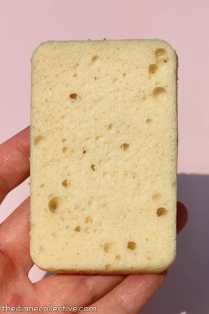 Rectangular slice of vanilla almond white cake with a pale crumb and small scattered holes